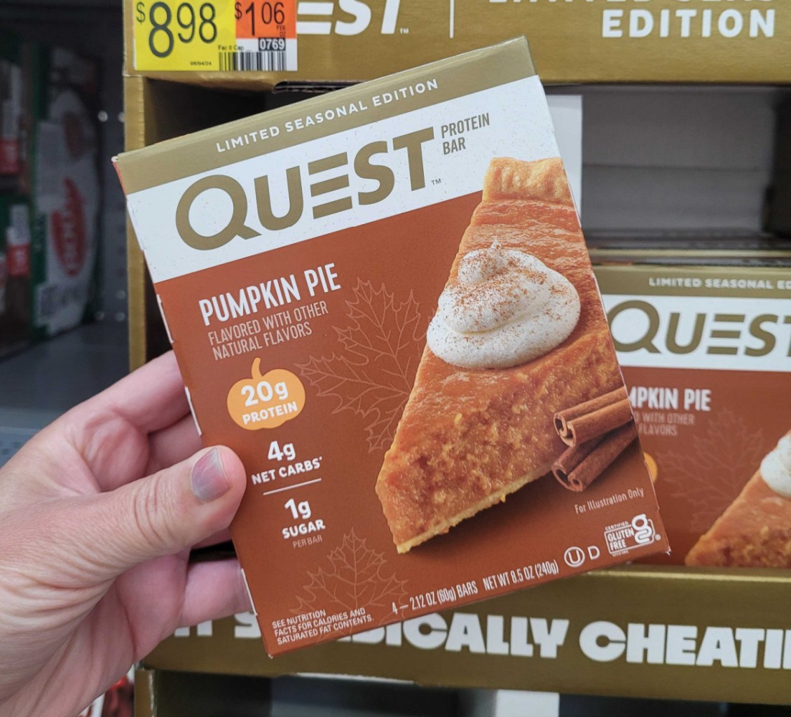 Hand holding a box of Quest Pumpkin Pie Protein Bars, one of the keto snacks at Walmart