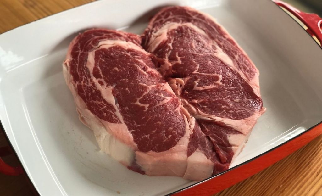 A raw steak in a baking dish