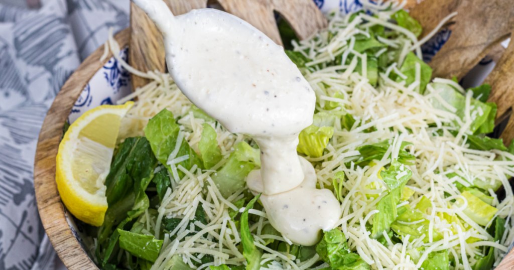tablespoon of dressing poured onto salad