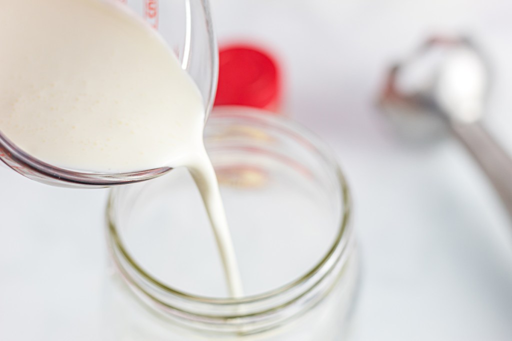 pouring heavy cream into jar