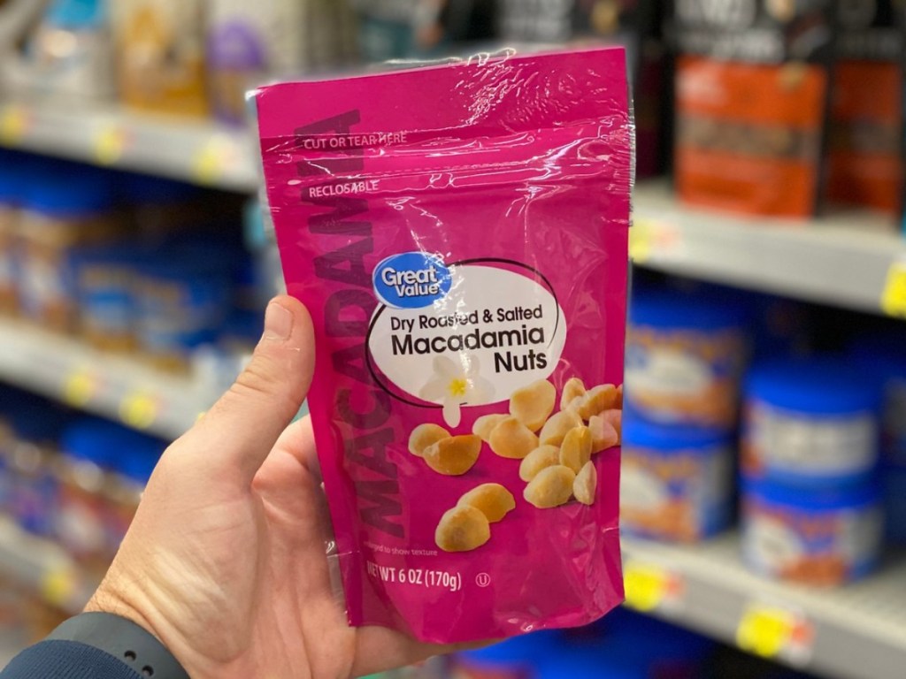 holding a bag of macadamia nuts at Walmart