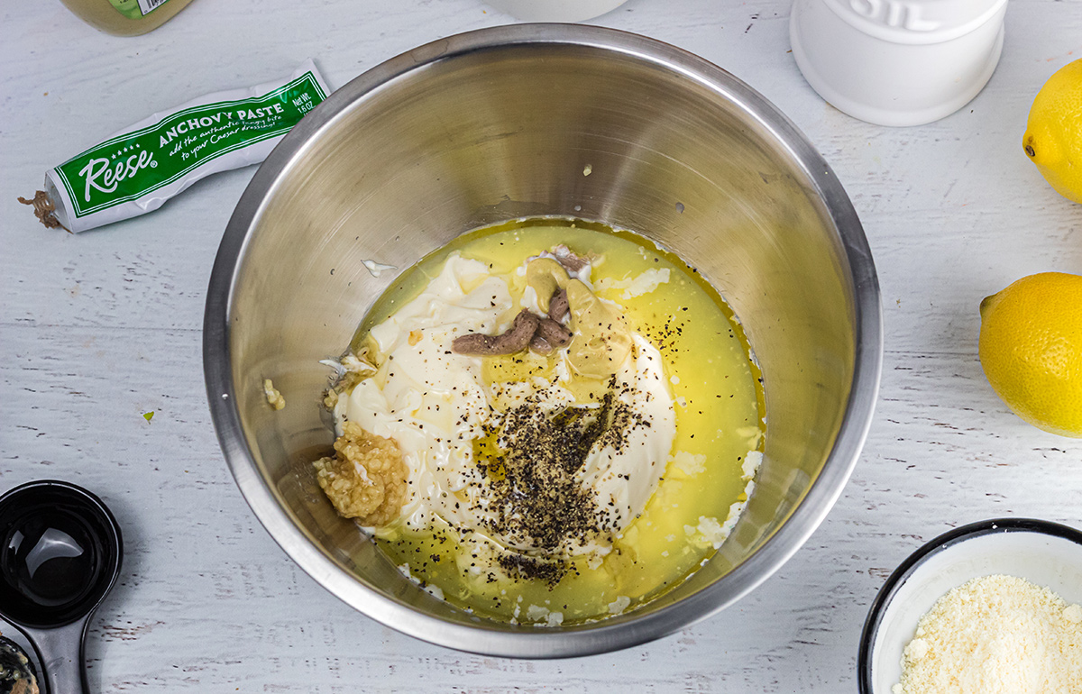 combining all salad dressing ingredients in a mixing bowl