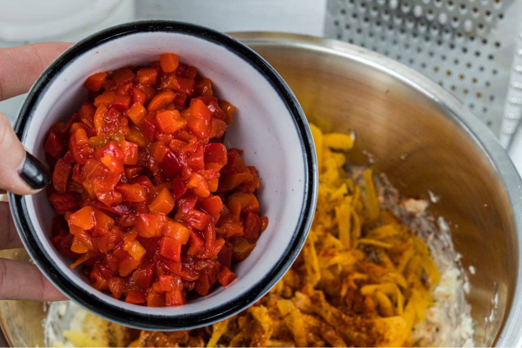 adding pimentos peppers to cheese