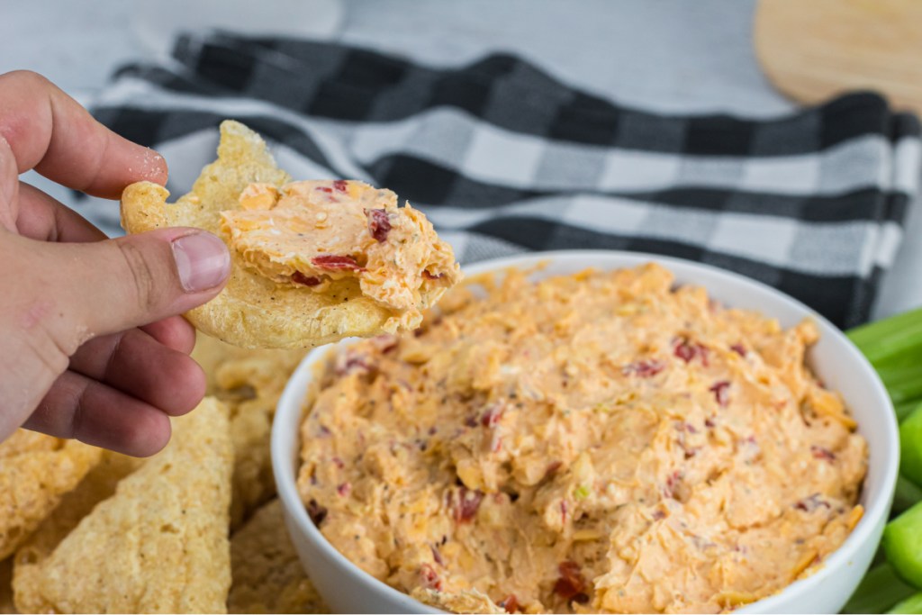 scooping pimento cheese with pork rinds