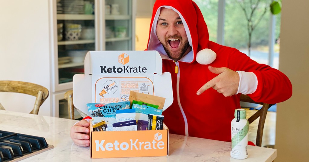 man in a Christmas onesie with a keto krate box