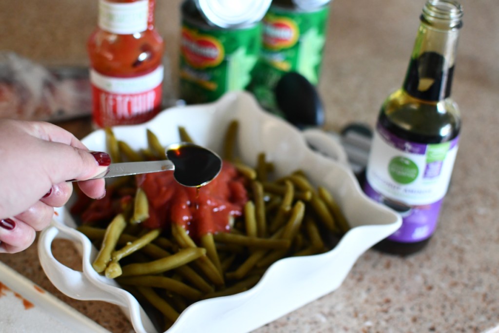 putting sauce on green beans