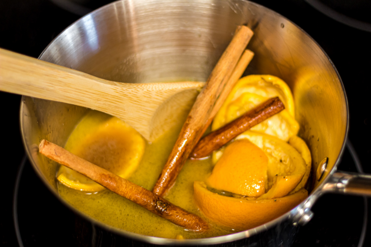 simmering sauce pan with butter, cinnamon, and orange peel