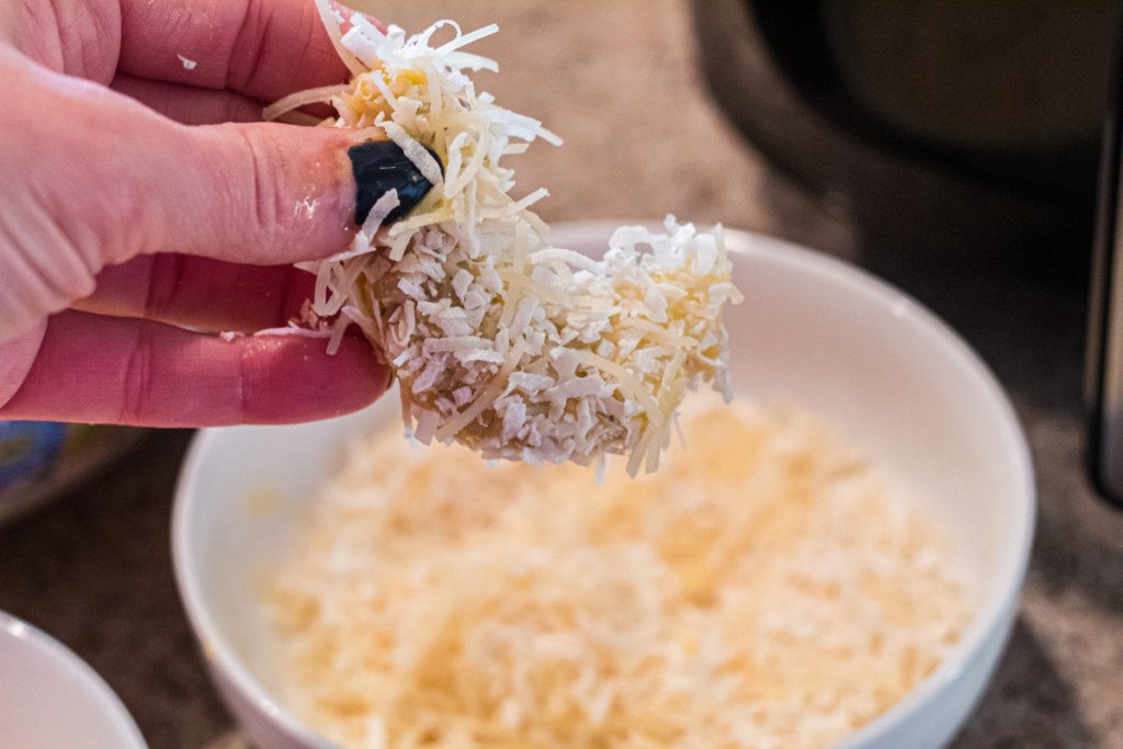 dipping shrimp into shredded coconut