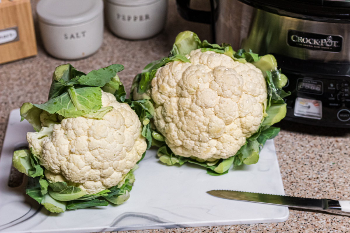 cauliflower heads on cutting board, one of the best keto vegetables to eat