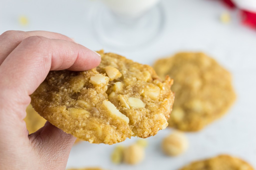 holding a Keto White Chocolate macadamia nut cookie