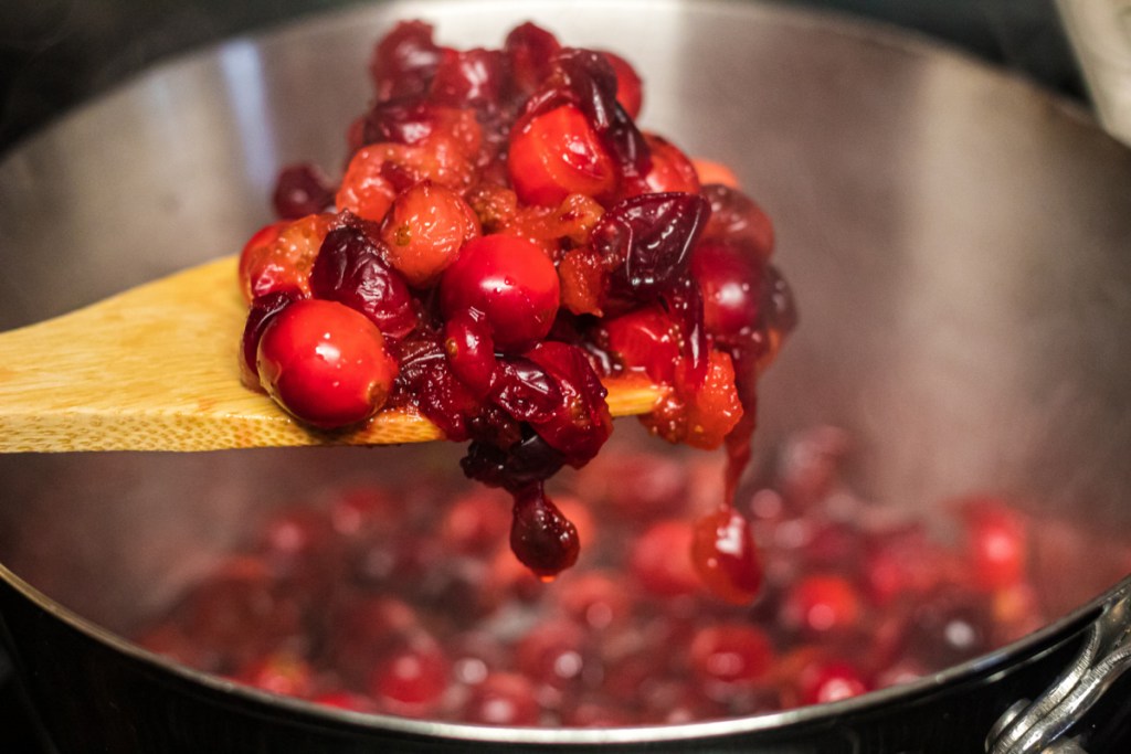 softened cranberries on a wooden spoon