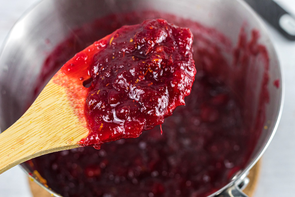 no sugar added cranberry sauce on wooden spoon