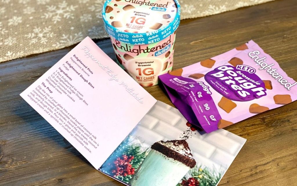 some ice cream and dough bites next to a recipe book on a table