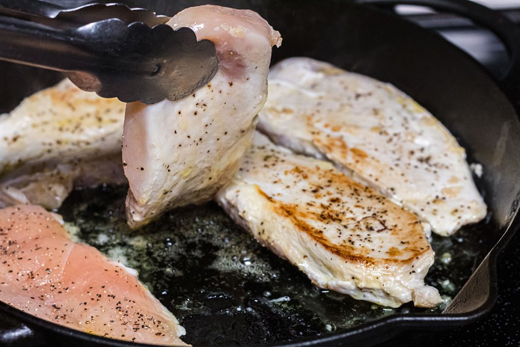 turning chicken breasts in cast iron pan