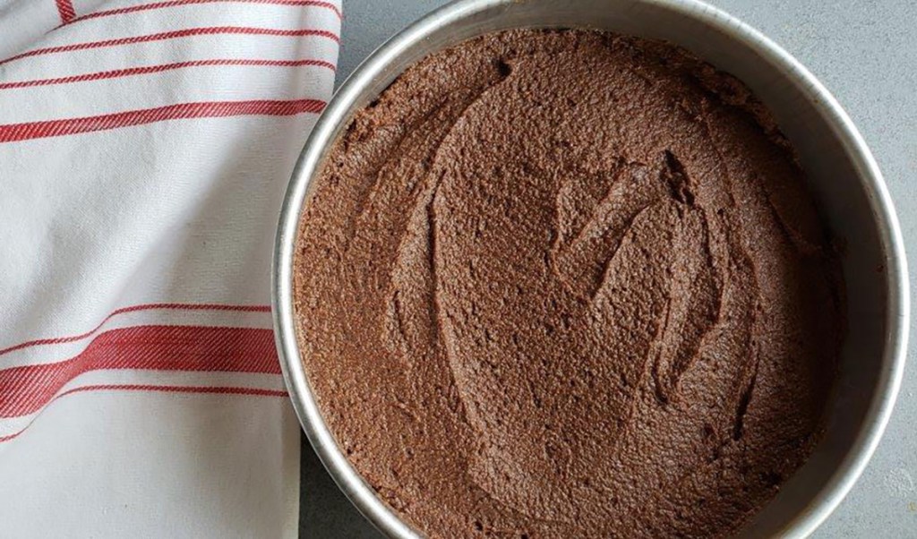 spreading chocolate cake batter in pan