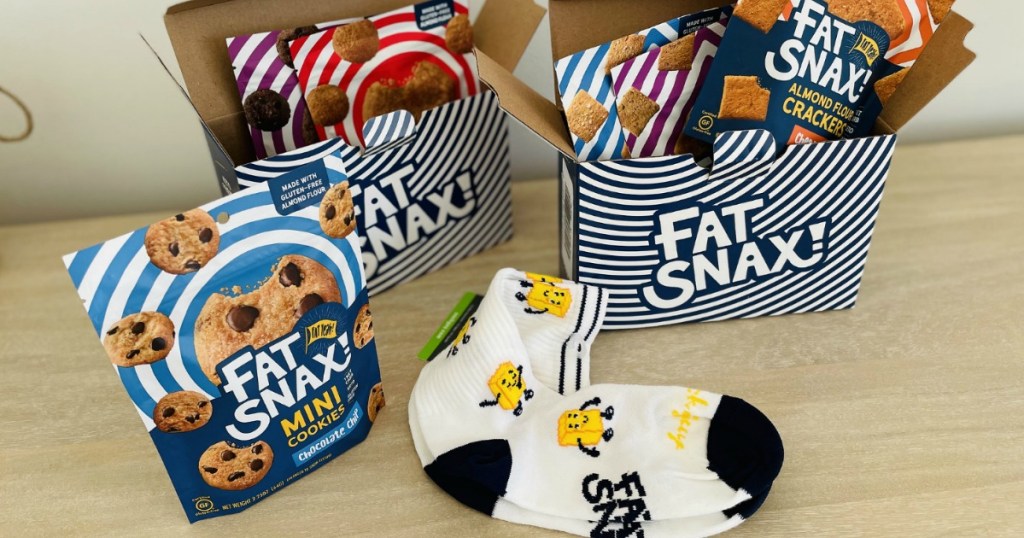 fat snax boxes with crackers and cookies and butter socks on table