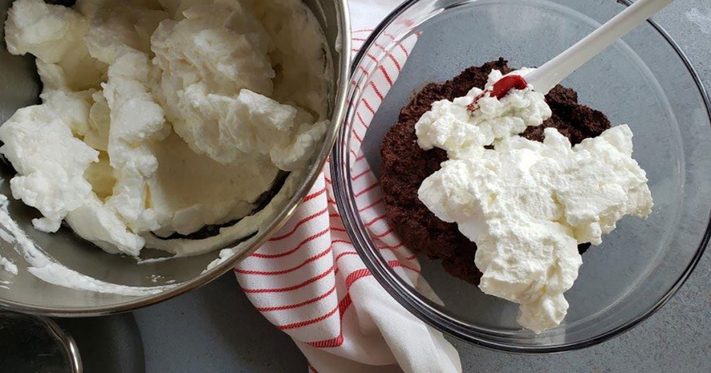 folding whipped egg whites into chocolate cake batter