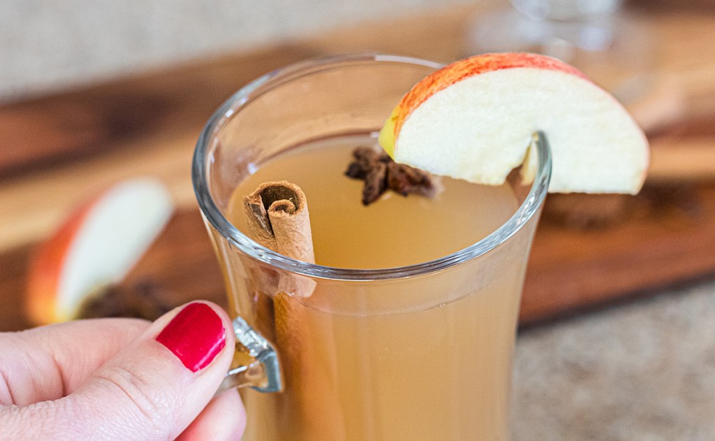 holding keto apple cider mug