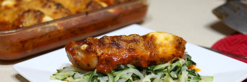 stuffed Italian sausage on plate with zoodles 