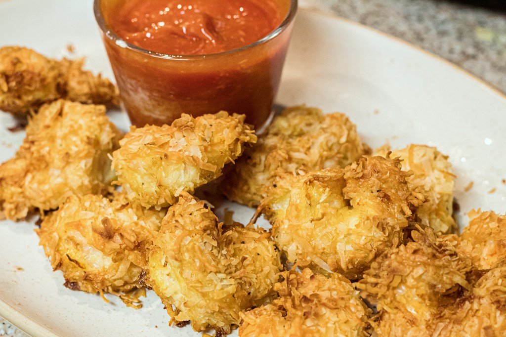 plate of keto coconut shrimp and cocktail sauce