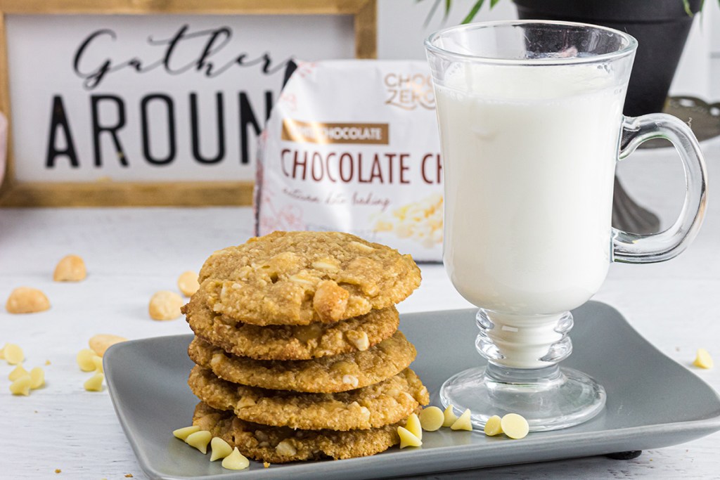 keto white chocolate macadamia nut cookies on plate with glass of almond milk