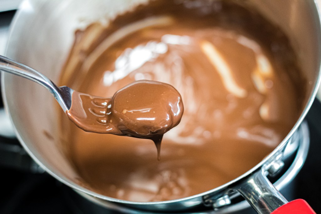 keto peppermint patty dipping into chocolate