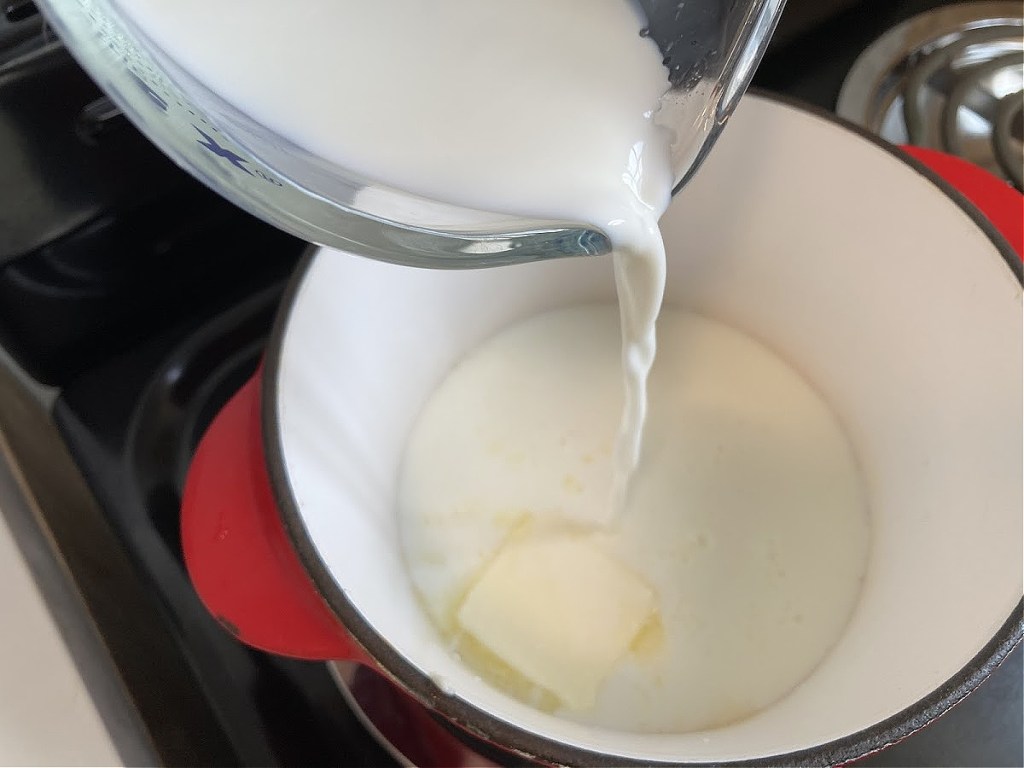 pouring cream into saucepan