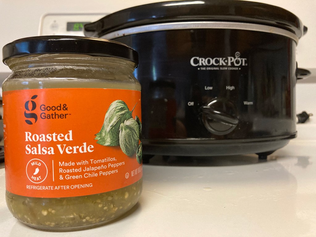 jar of salsa verde in front of crock pot