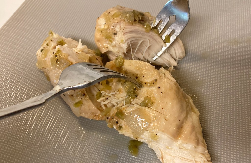 two forks shredding chicken breast