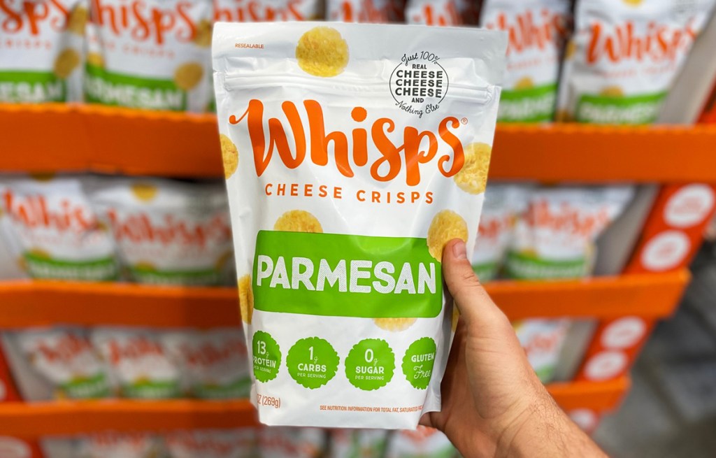 hand holding bag of whisps cheese crisps