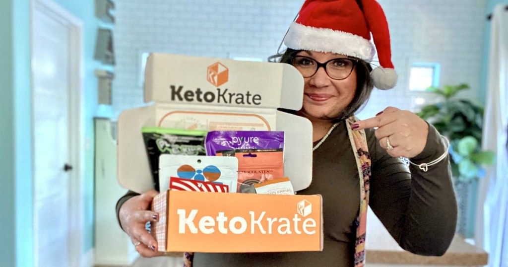 woman in santa hat holding a keto krate