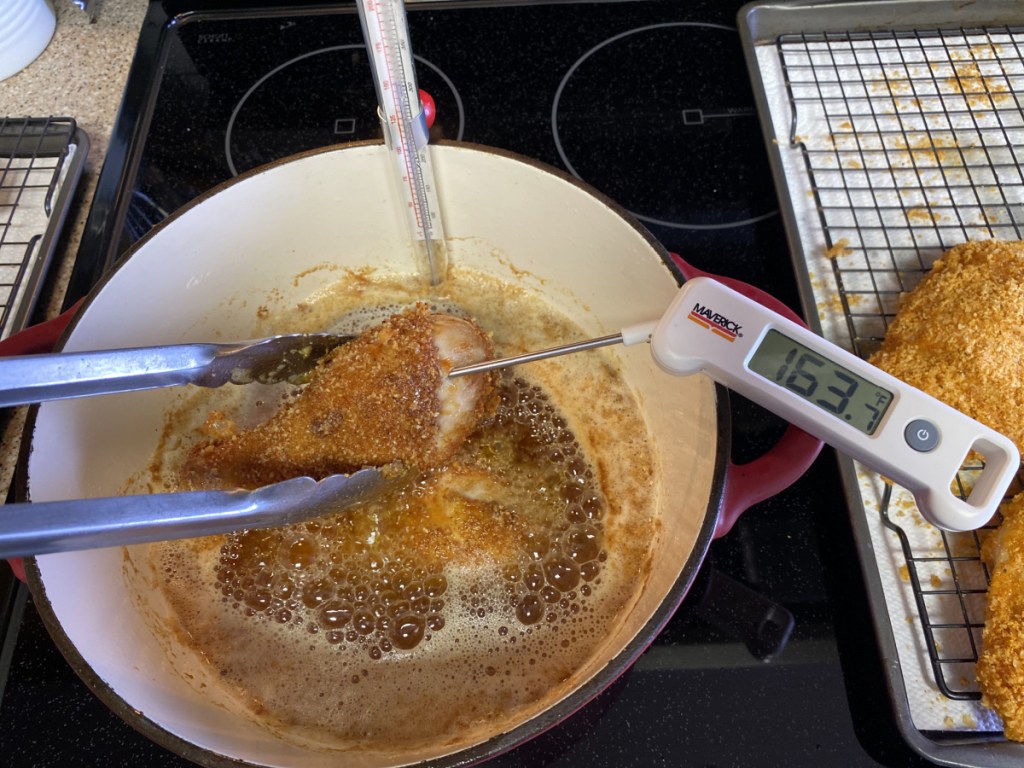 checking internal temperature of cooked chicken