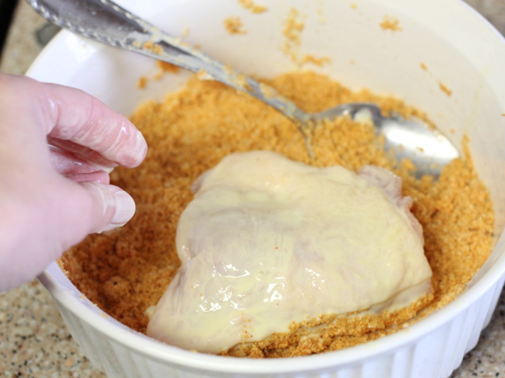 adding breading to chicken