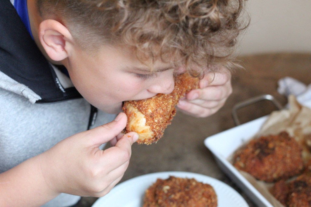 boy eating a keto chicken drumstick