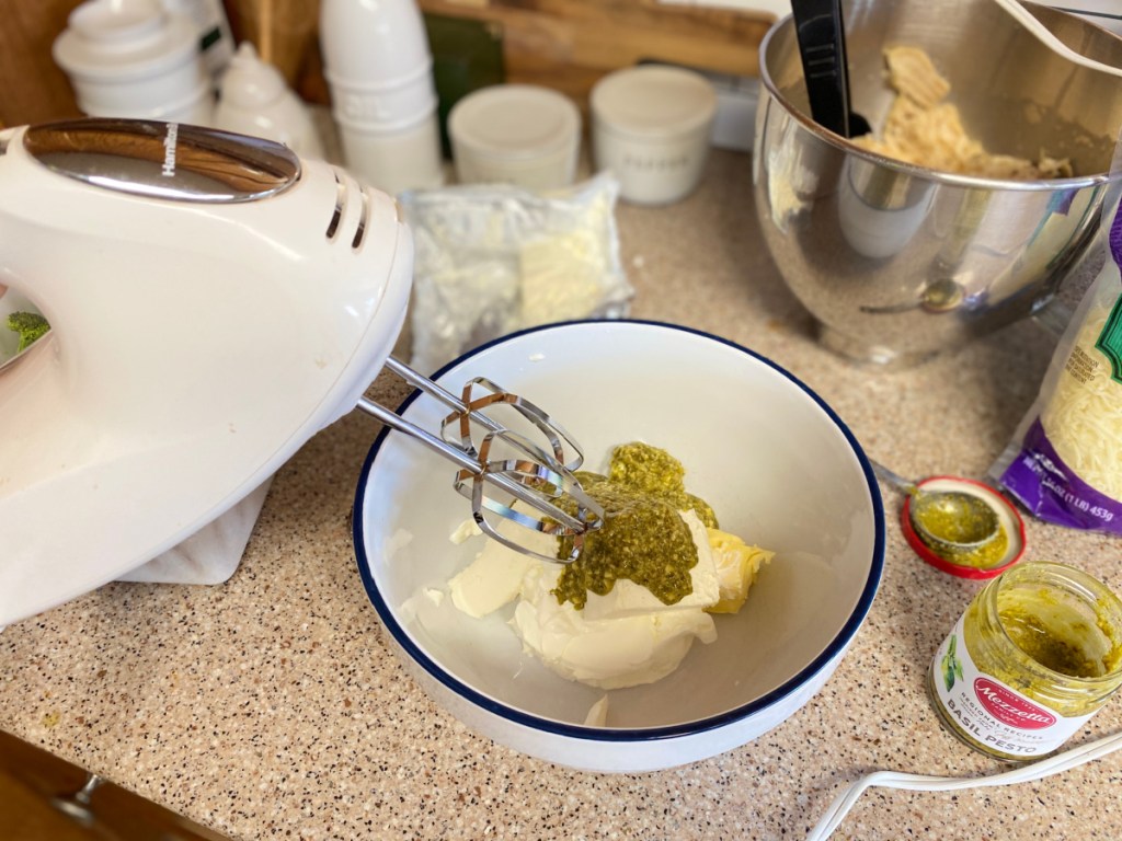 mixing pesto sauce in a bowl