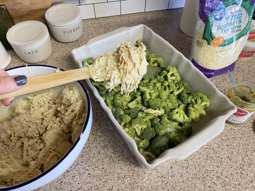 adding chicken to a baking dish