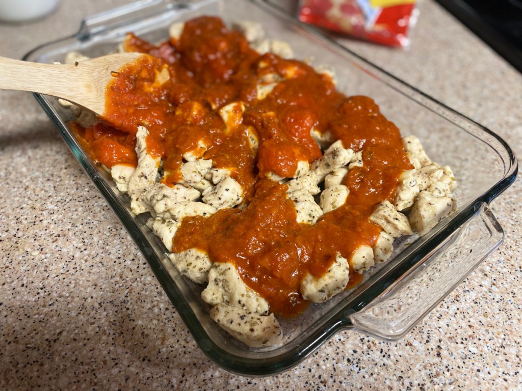 pizza sauce over cubed chicken