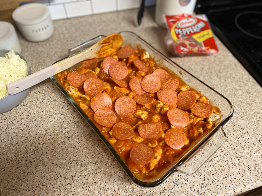 pepperoni over cubed chicken and pizza sauce