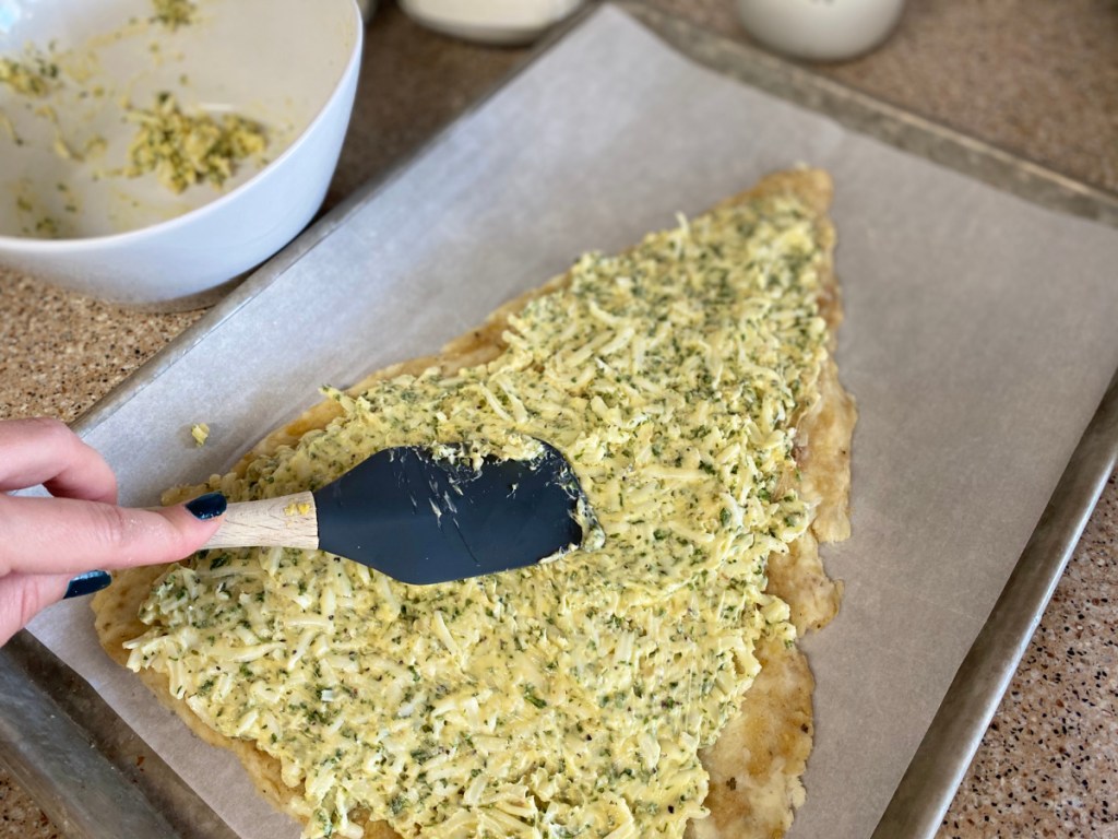 spreading out butter filling on easy keto dough