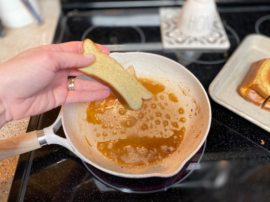 adding sliced keto bread to a skillet