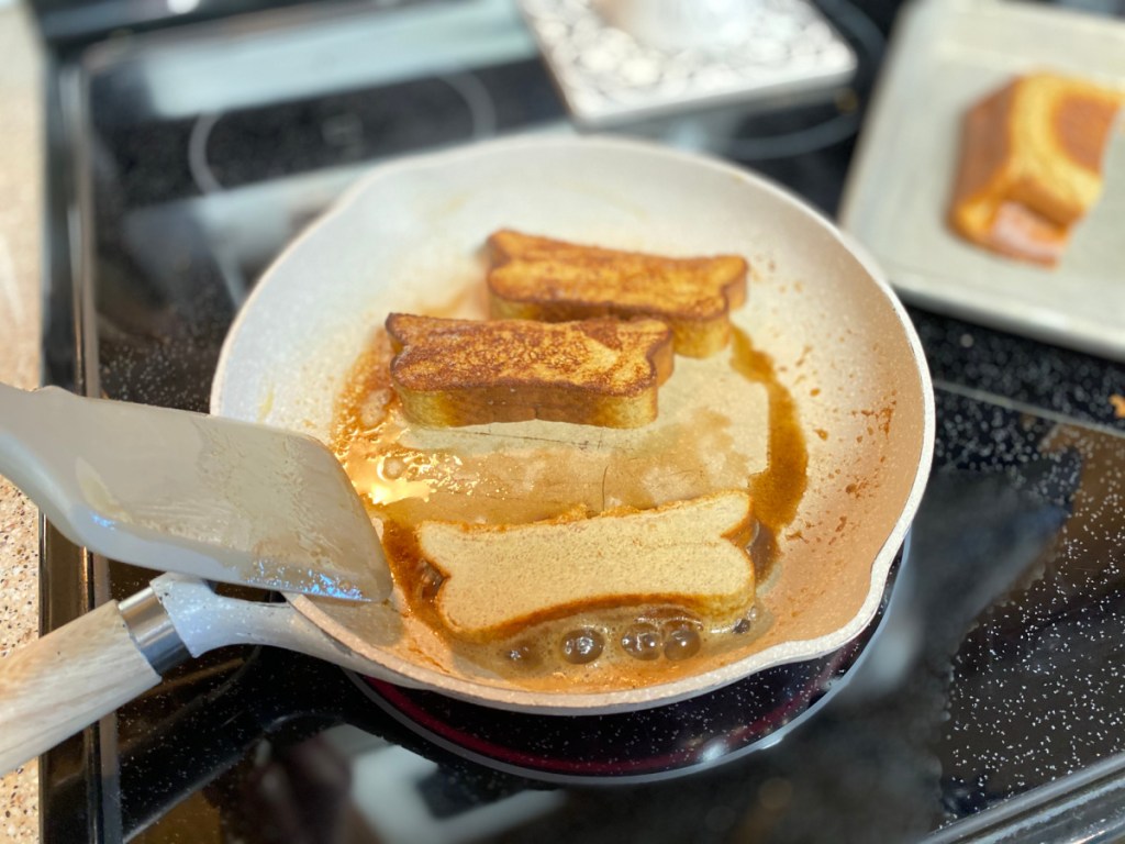 flipping keto french toast over in a skillet