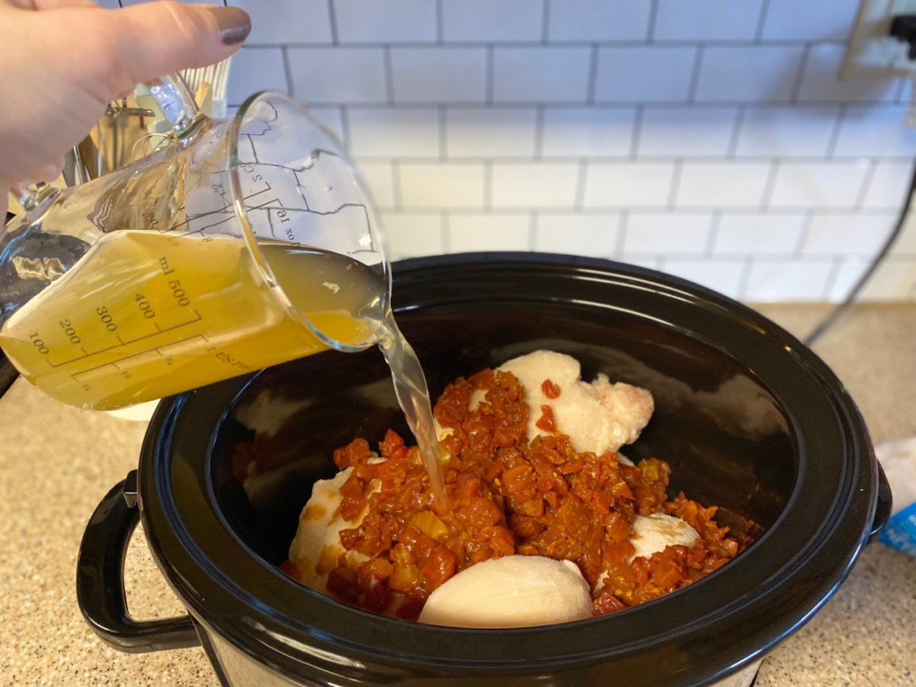 pouring chicken broth into slow cooker