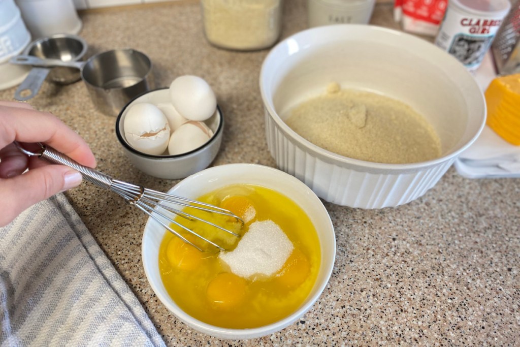 whisking granular and eggs in a bowl