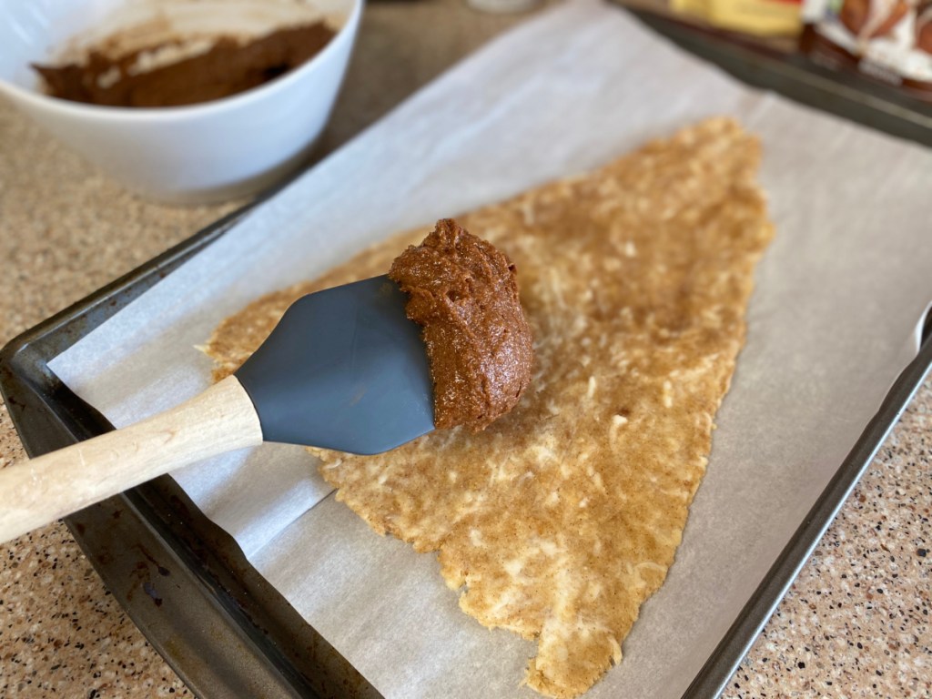 spreading filling on sweet dough