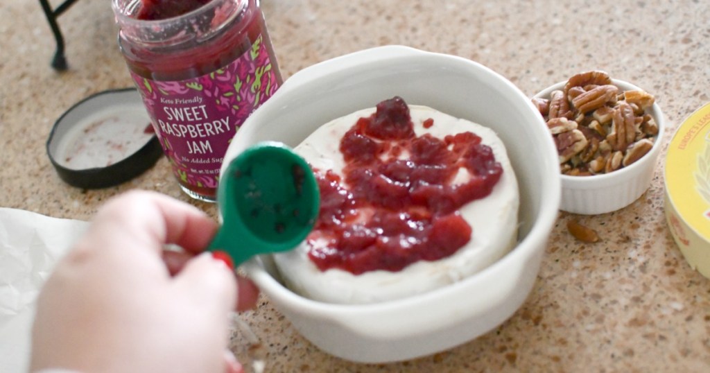 adding jam to top of brie