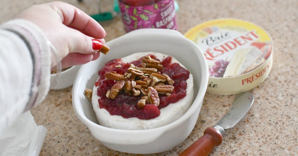 adding pecans to top of brie