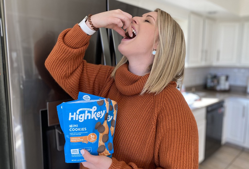 woman eating high key cookies in kitchen