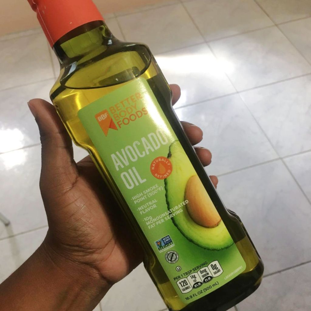 holding bottle of olive oil