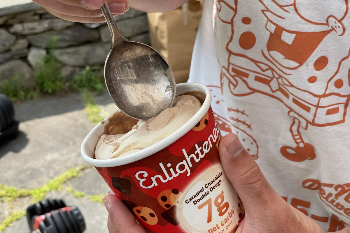 scooping a spoon of Enlightened keto double dough ice cream