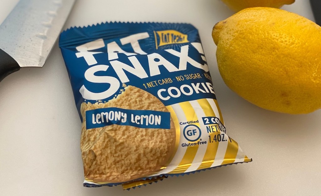 fat snax lemon cookie on counter in bag with knife and fresh lemon